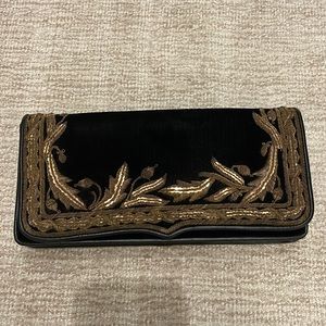 Ralph Lauren Purple Label black velvet clutch with gold detail.